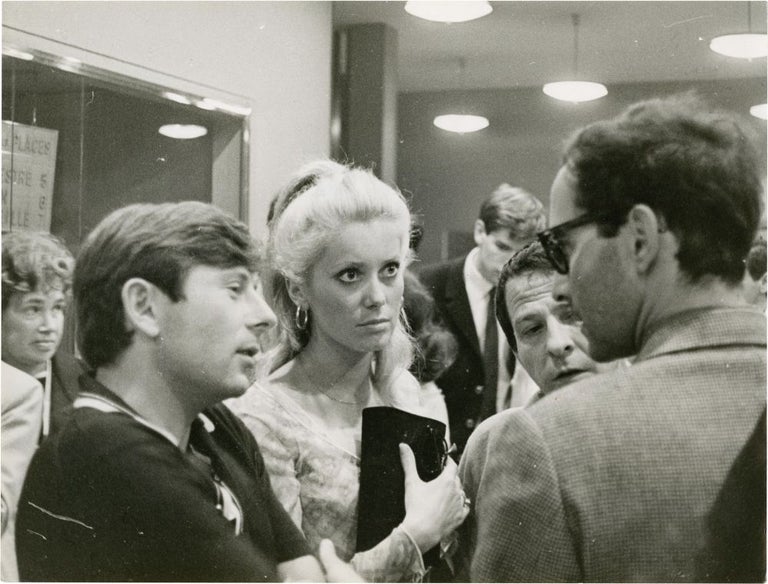 [Book #127342] Original candid photograph of Roman Polanski, Jean-Luc Godard, and Catherine Deneuve at Cannes, 1965. Claude Schwartz, Jean-Luc Godard Roman Polanski, Catherine Deneuve, photographer, directors, actress.