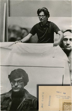 Book #136158] Richard Avedon holds up photograph of Rennie Davis (Original Chicago Tribune press...
