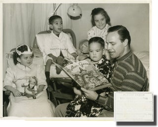 Book #140810] Original photograph of Marlon Brando reading to children. Marlon Brando, subject