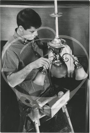 Two original photographs of Jerry Lewis changing a light bulb, circa 1950s