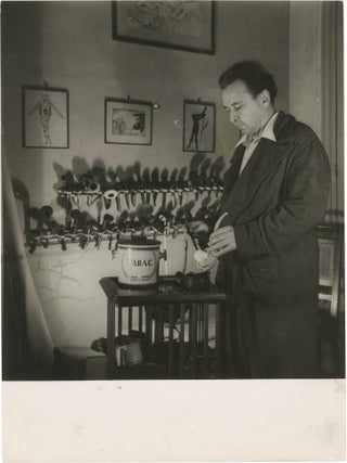 Book #150481] Original photograph of Arthur Honegger filling his pipe, circa 1940s. Arthur...