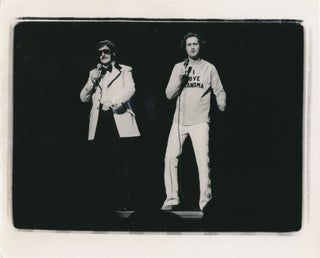 Book #151638] Collection of three original photographs of Andy Kaufman performing onstage, circa...