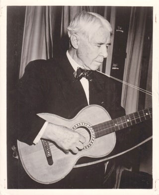 Book #152333] Original photograph of Carl Sandburg playing the guitar, circa 1955. Carl Sandburg,...