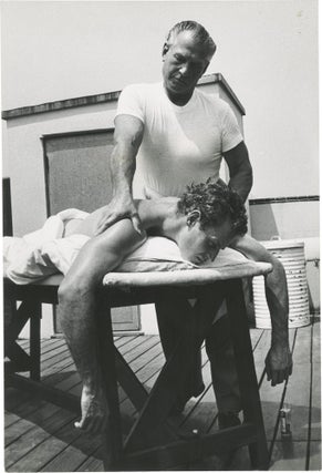 Book #152724] Arrowhead (Original oversize photograph of Charlton Heston receiving a massage on...