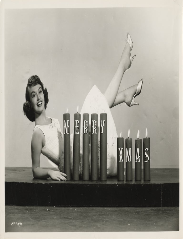 Original photograph of Janette Scott posing with a Christmas candle display, circa 1956