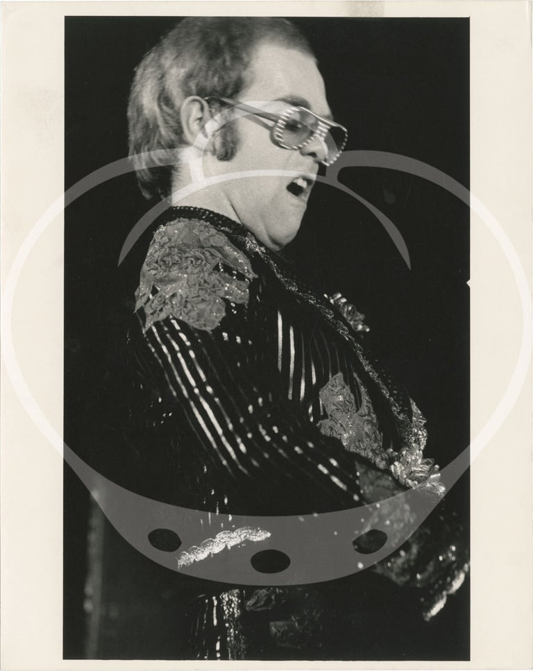 Collection of thirteen original photographs of Elton John, circa 1970s