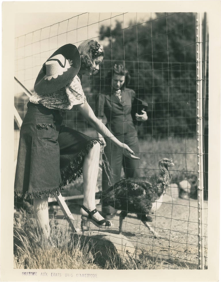 Book #158660] Original photograph of Lucille Ball with a turkey, circa 1940s. Lucille Ball,...