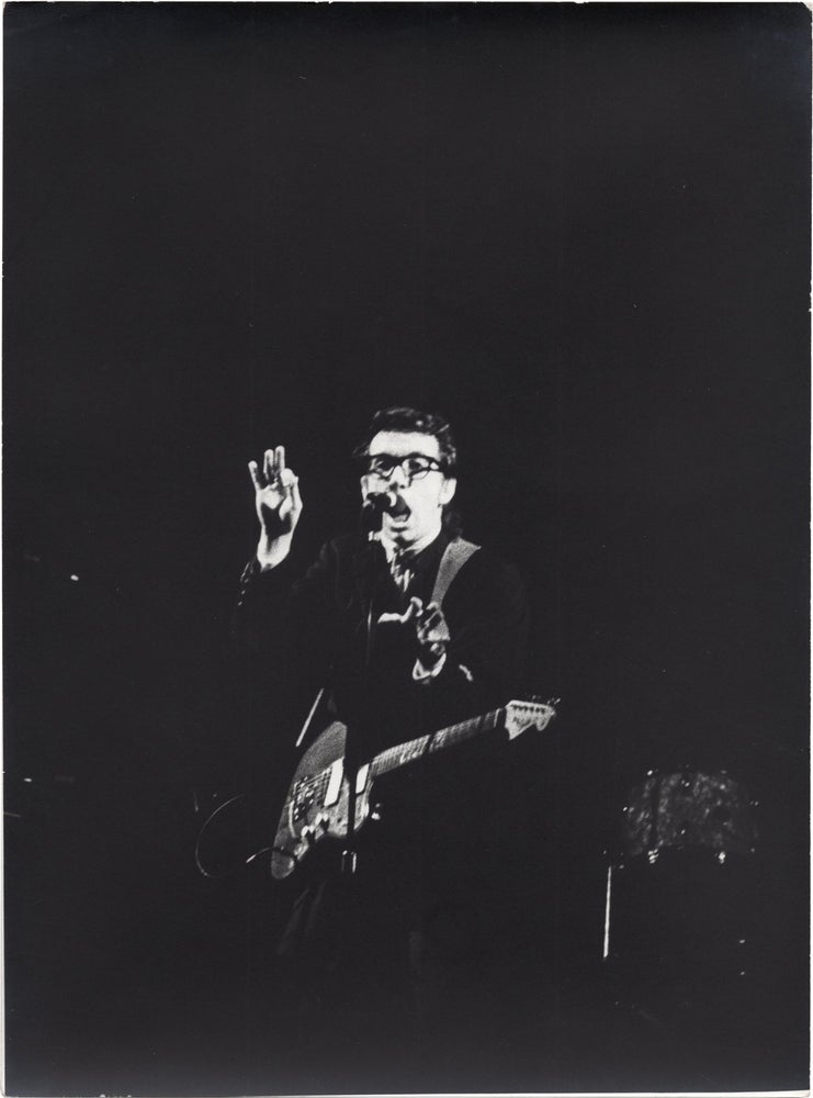 Book #159118] Three original photographs of Elvis Costello onstage, circa 1980s. Elvis Costello,...