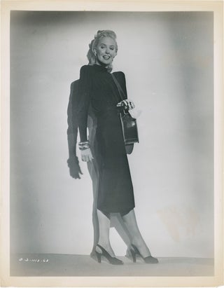 Book #160104] Framed (Three original photographs of Janis Carter from the 1947 film noir)....
