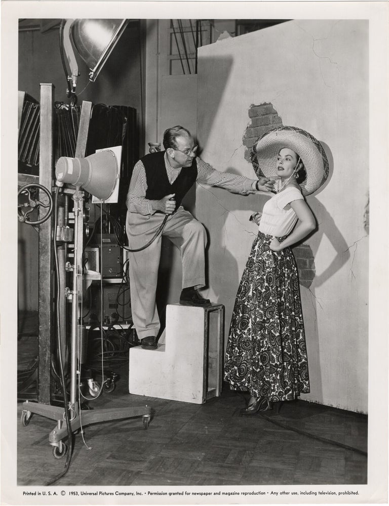 Book #165557] Original photograph of Ann Sheridan in a portrait studio with Ray Jones, 1953. Ray...