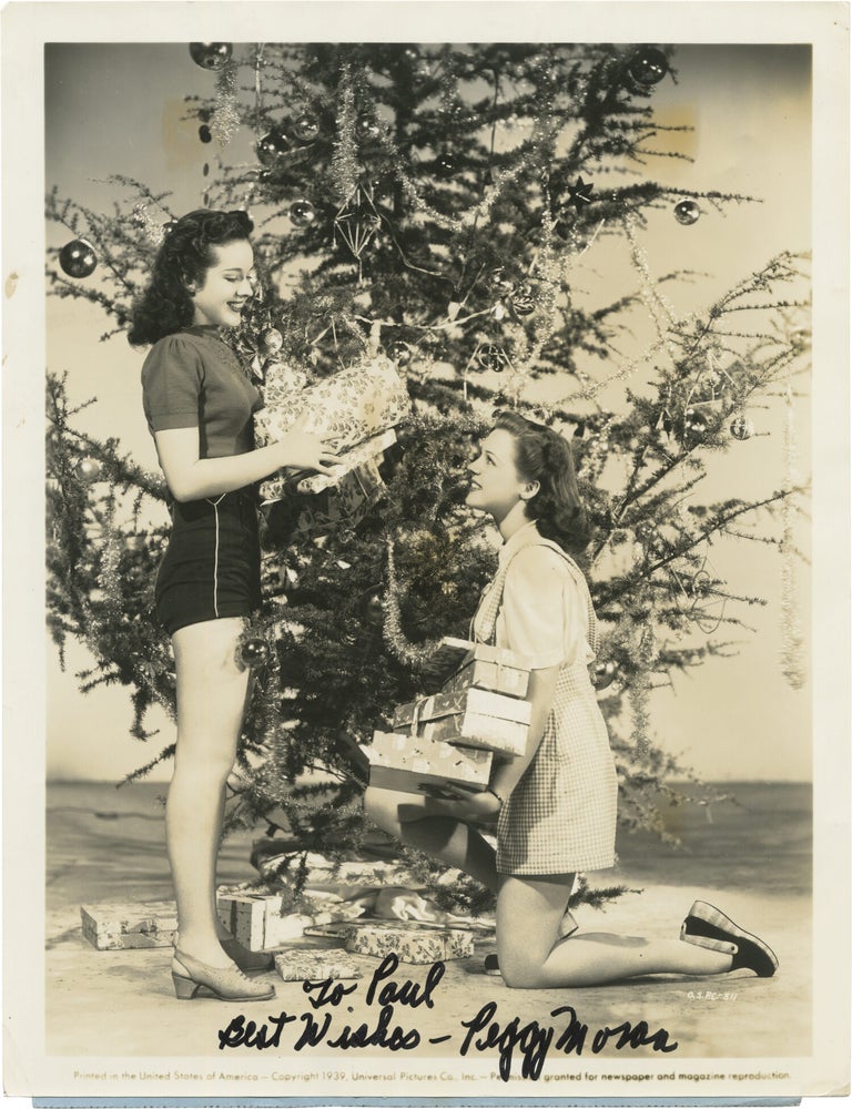 Book #165997] Original Christmas publicity photograph of Peggy Moran and Anne Gwynne, inscribed...