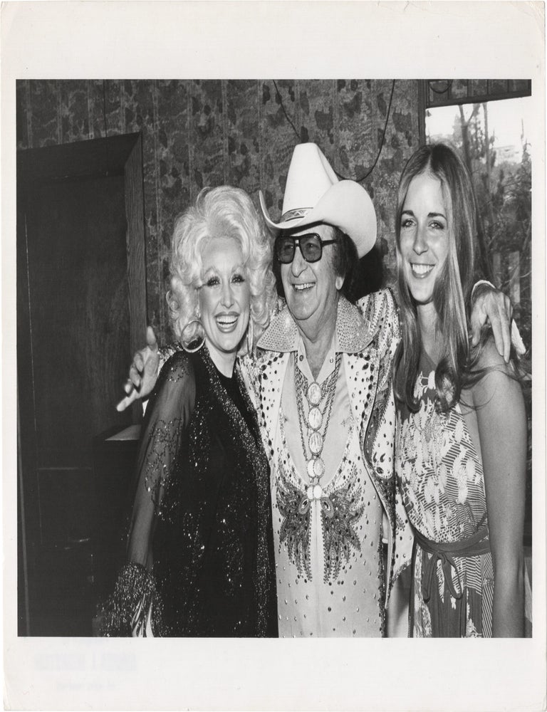 Two original photographs of Dolly Parton and Carlene Carter with Emmylou Harris and Nudie Cohn, circa 1978