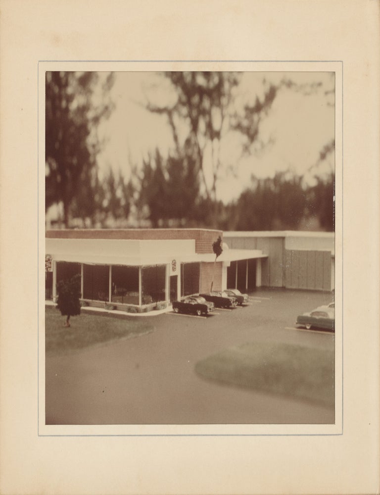 Six original photographs of a miniature model of a Cadillac dealership