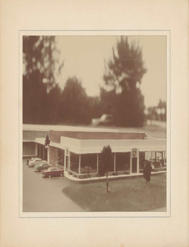 Six original photographs of a miniature model of a Cadillac dealership